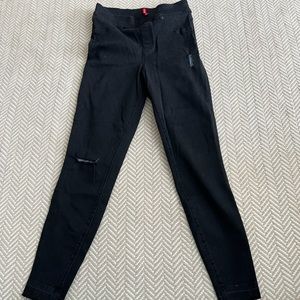 Spanx black skinny jeans with raw hem. Very flattering!